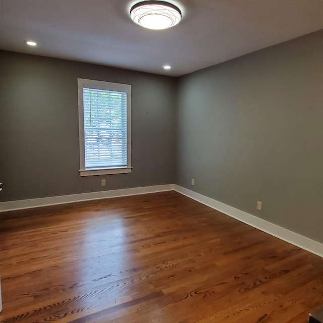 unfurnished room featuring dark hardwood / wood-style flooring