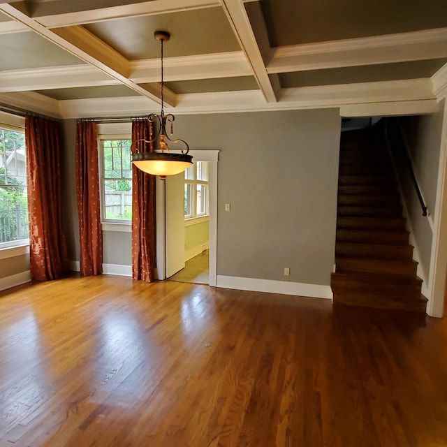 interior space featuring coffered ceiling, wood-type flooring, plenty of natural light, and beamed ceiling