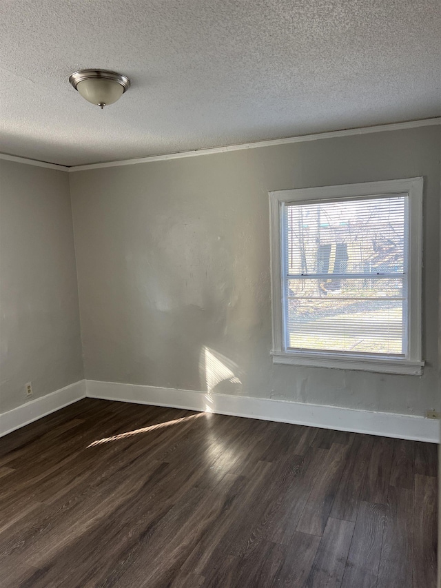 unfurnished room with a textured ceiling, crown molding, and dark wood-type flooring