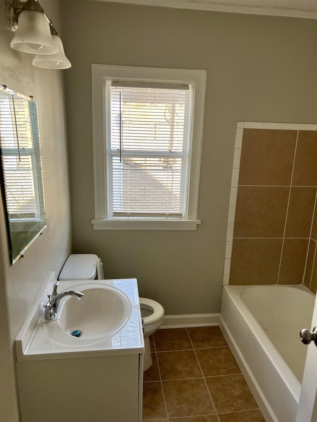 bathroom featuring vanity, a wealth of natural light, tile patterned floors, and toilet