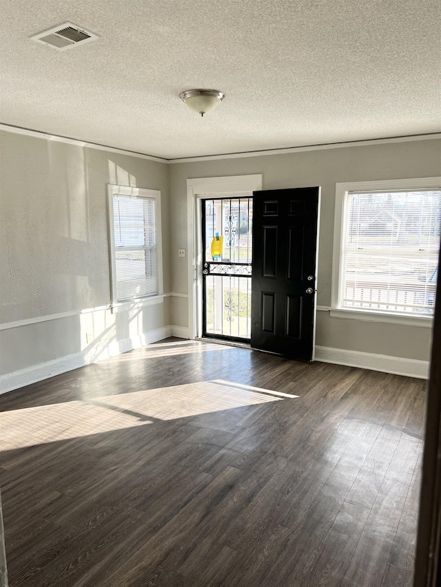 entrance foyer featuring a textured ceiling and dark hardwood / wood-style flooring