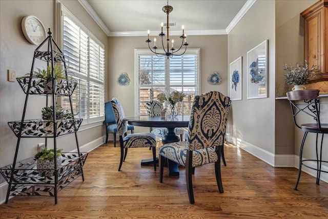 dining space with a notable chandelier, crown molding, and plenty of natural light