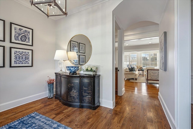 hall with ornamental molding and dark hardwood / wood-style flooring