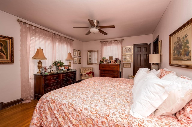 bedroom with ceiling fan and hardwood / wood-style floors