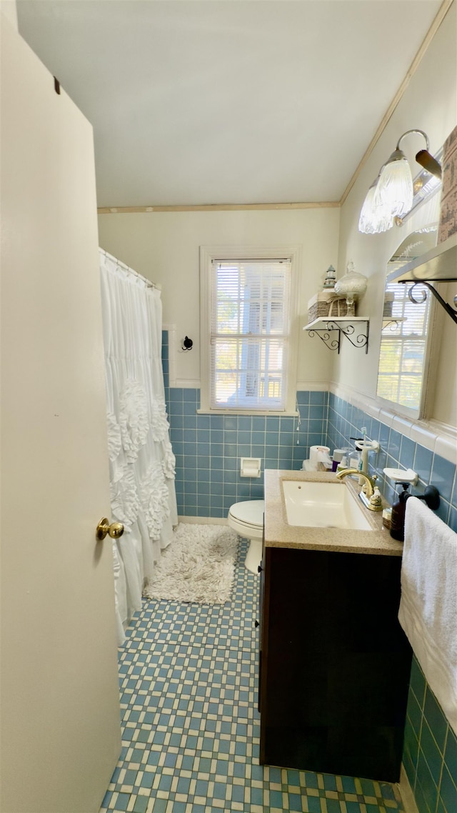 bathroom featuring tile walls, a shower with curtain, vanity, and toilet