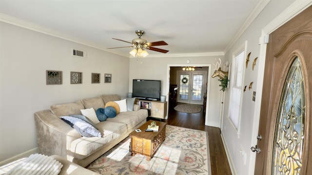 living room with ceiling fan with notable chandelier, french doors, ornamental molding, and dark hardwood / wood-style floors