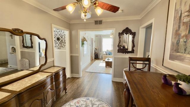 foyer entrance featuring ornamental molding, ceiling fan, and dark wood-type flooring