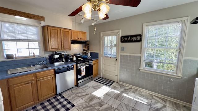 kitchen with appliances with stainless steel finishes, ceiling fan, and plenty of natural light