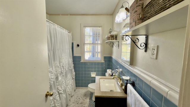 bathroom with tile walls, a shower with curtain, vanity, and toilet