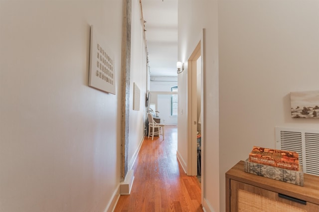 hallway with hardwood / wood-style floors