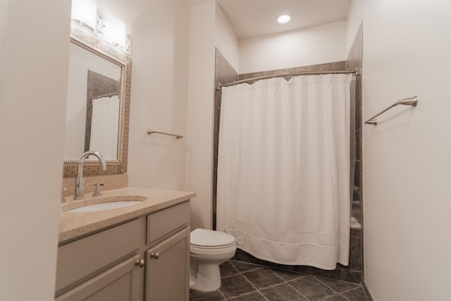 bathroom featuring tile patterned floors, vanity, and toilet