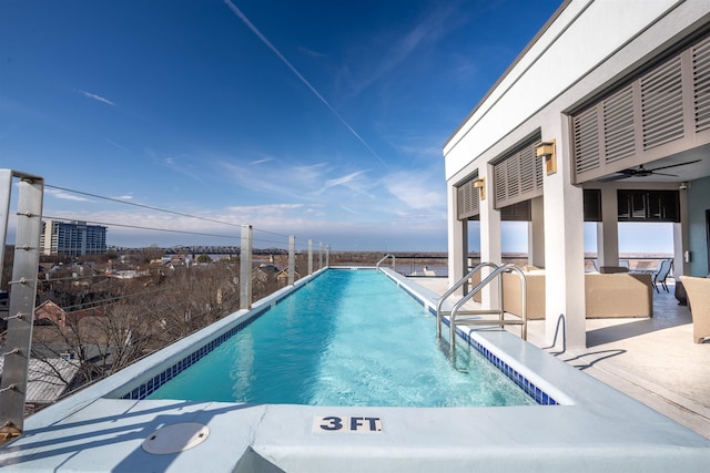 view of pool with a patio area and ceiling fan