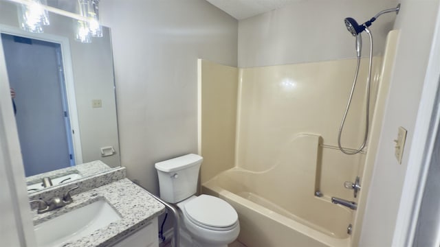 full bathroom with shower / bathing tub combination, vanity, toilet, and a textured ceiling