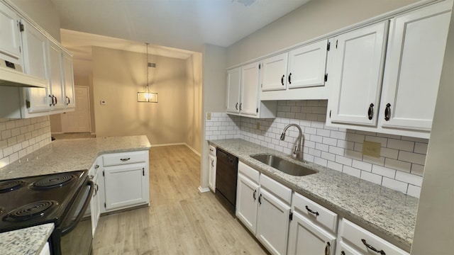 kitchen featuring sink, white cabinets, light stone counters, and black appliances