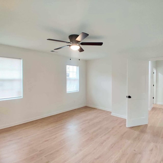 spare room with ceiling fan and light hardwood / wood-style flooring