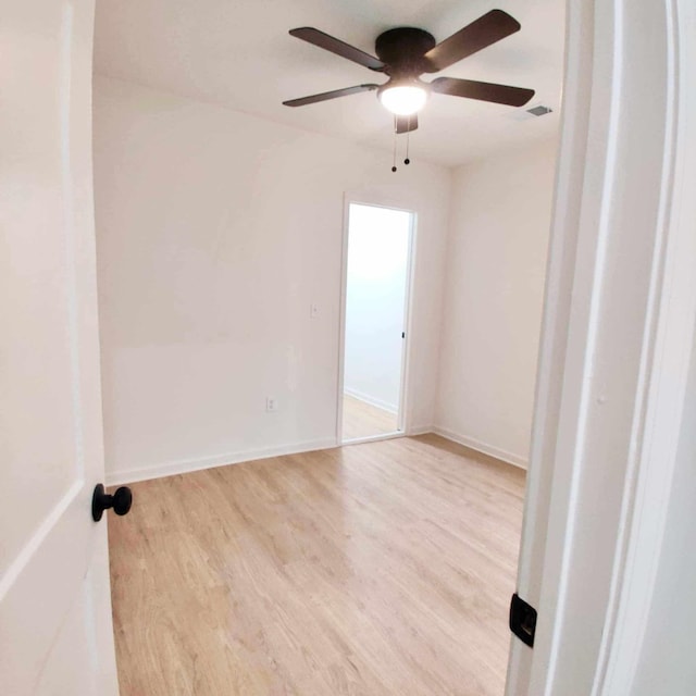 spare room featuring ceiling fan and light hardwood / wood-style floors