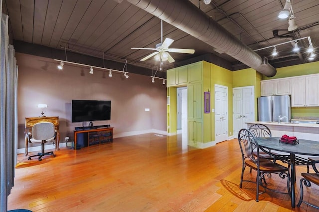 interior space with track lighting, ceiling fan, light hardwood / wood-style floors, and sink