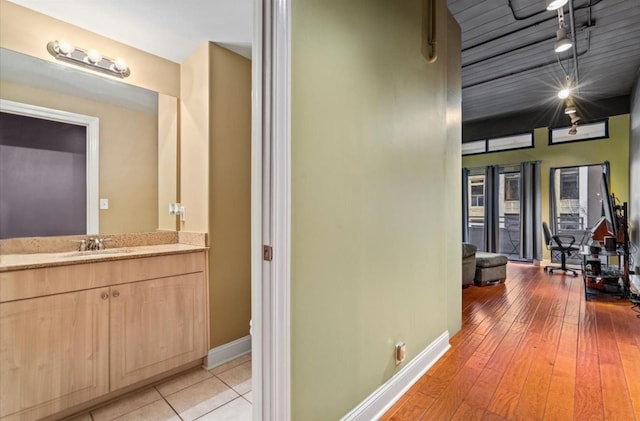 corridor with sink and light hardwood / wood-style floors