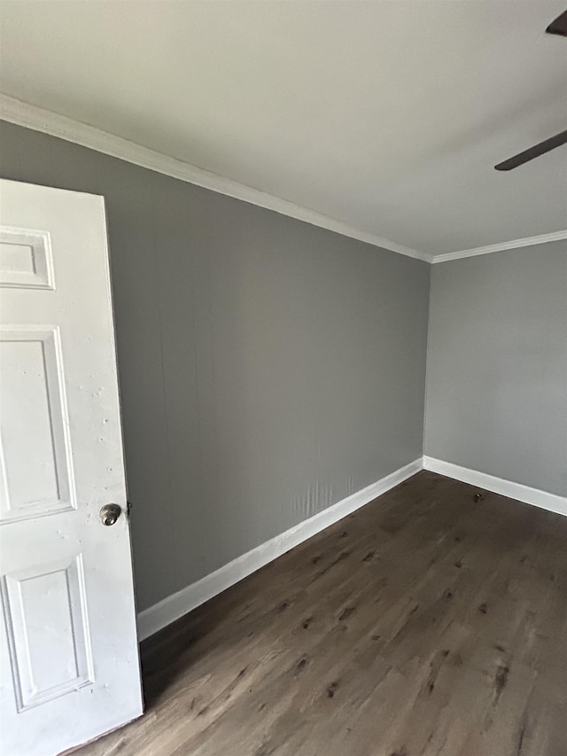 empty room with ceiling fan, crown molding, and dark hardwood / wood-style floors