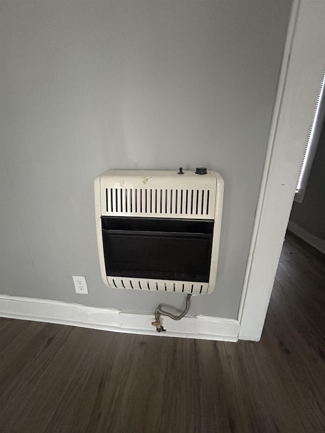 room details featuring hardwood / wood-style floors and heating unit