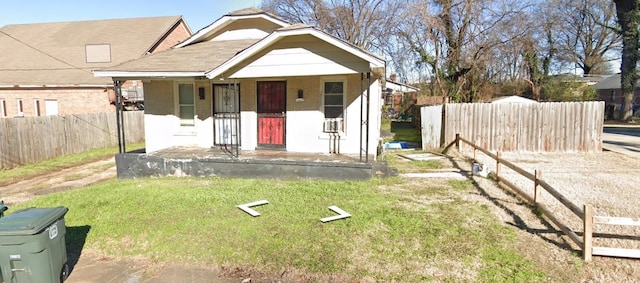 bungalow-style home with covered porch and a front lawn