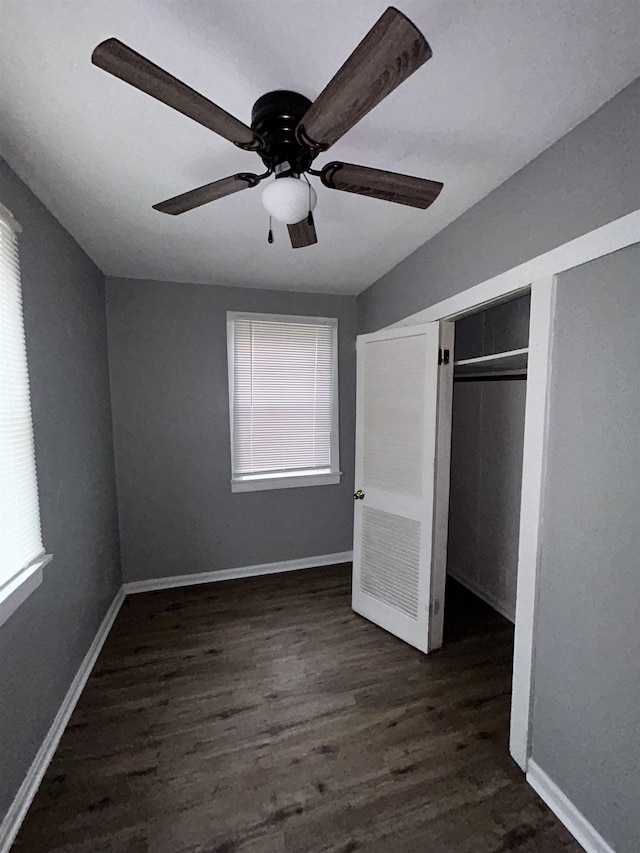 unfurnished bedroom featuring a closet, ceiling fan, and dark hardwood / wood-style floors