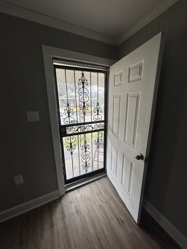 foyer entrance featuring wood-type flooring and ornamental molding