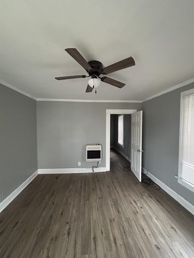 unfurnished living room featuring dark wood-type flooring, ceiling fan, crown molding, and heating unit