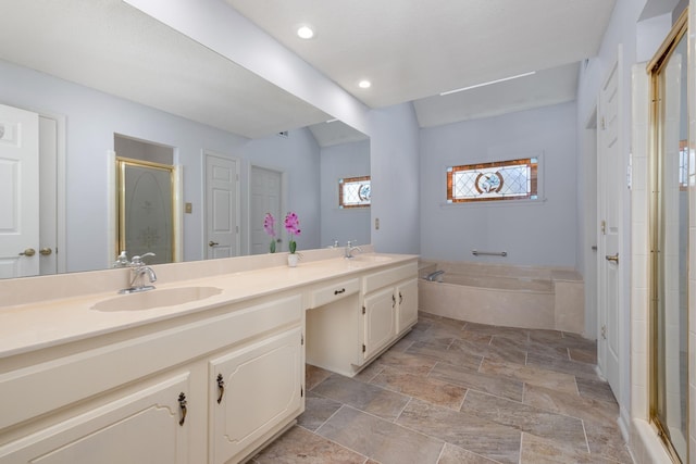 bathroom with vanity and independent shower and bath