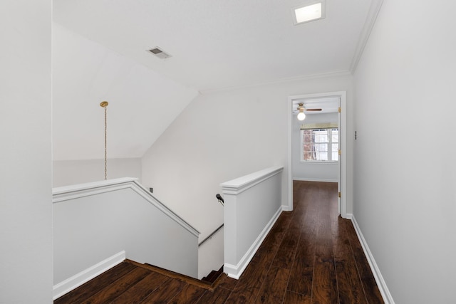 corridor with vaulted ceiling and hardwood / wood-style flooring