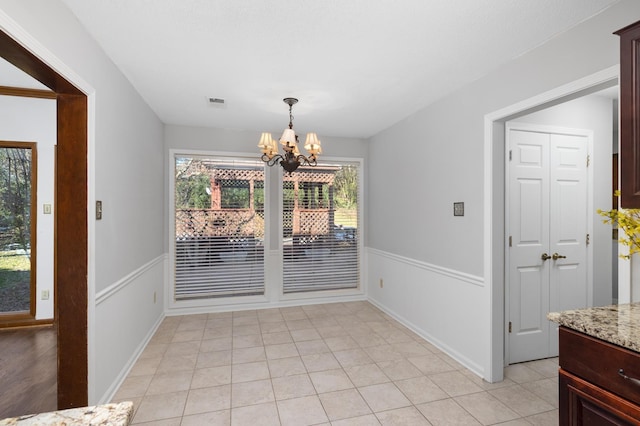 tiled dining area featuring a notable chandelier