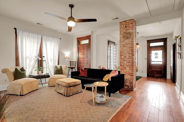 living room featuring ceiling fan and wood-type flooring