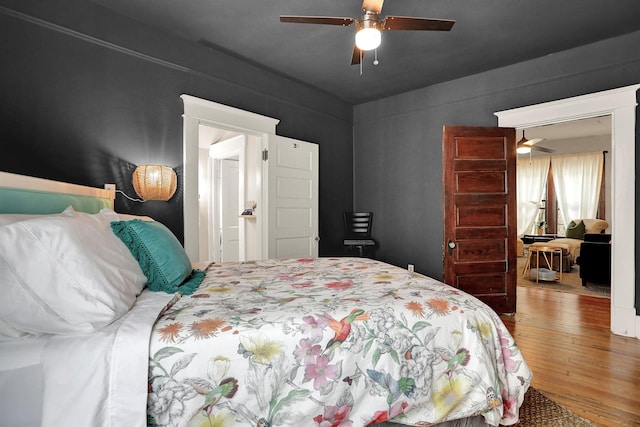 bedroom with ceiling fan and hardwood / wood-style flooring