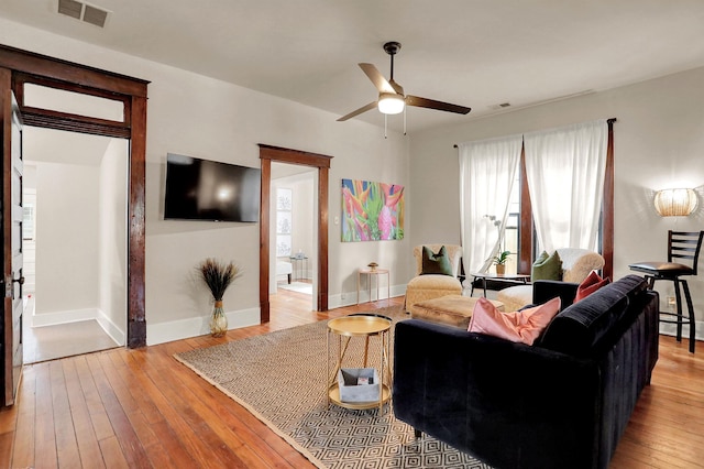 living room with ceiling fan and light hardwood / wood-style floors