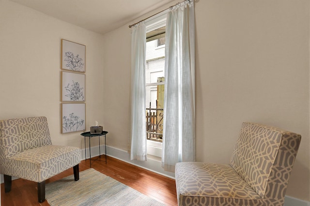 living area with hardwood / wood-style flooring