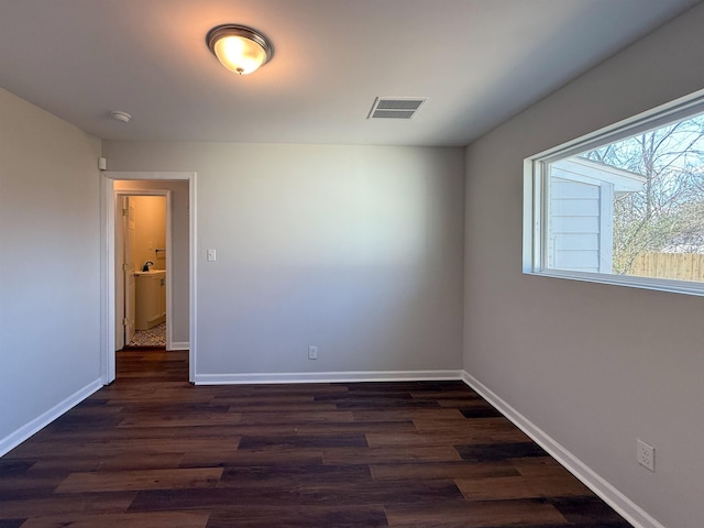 empty room with dark hardwood / wood-style flooring