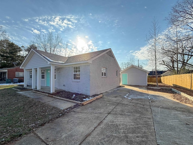 view of home's exterior with a porch, a garage, and an outdoor structure