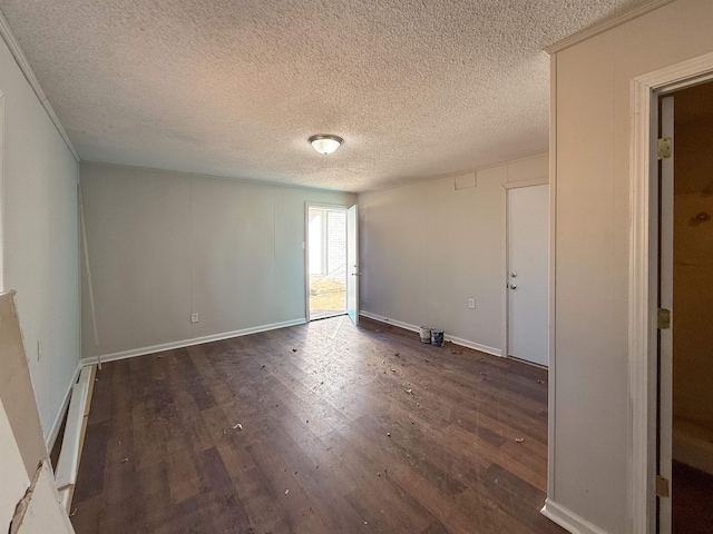 empty room featuring a textured ceiling and dark hardwood / wood-style flooring