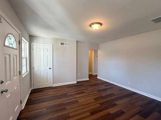 interior space featuring dark hardwood / wood-style flooring and a closet