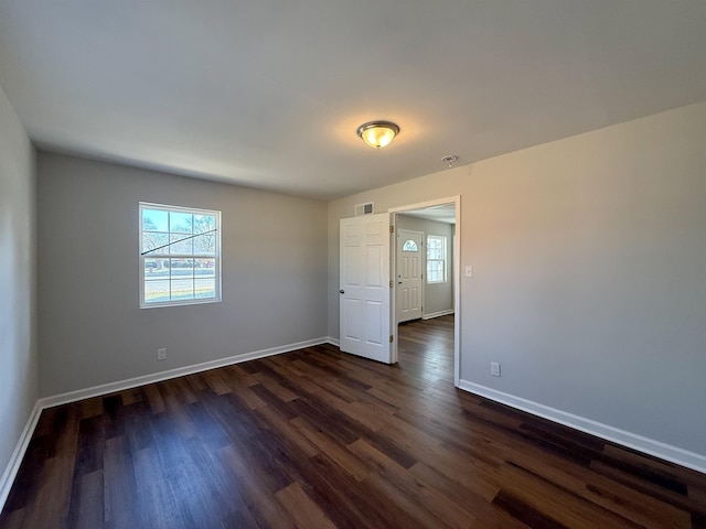 spare room featuring dark wood-type flooring