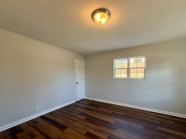 spare room with dark hardwood / wood-style floors