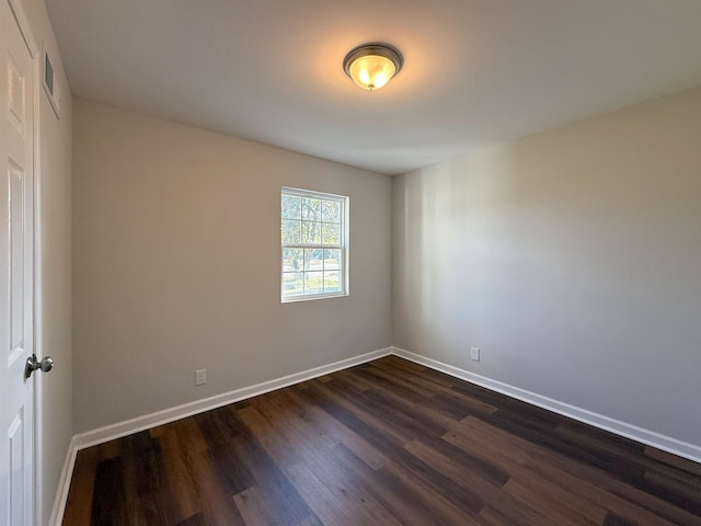 empty room with dark wood-type flooring