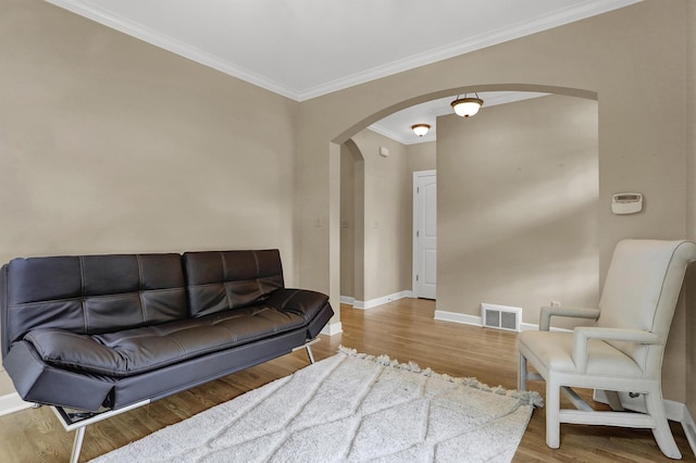 living room with ornamental molding and hardwood / wood-style flooring