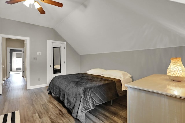 bedroom featuring ceiling fan, lofted ceiling, and wood-type flooring