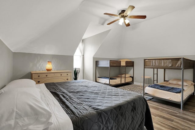 bedroom featuring ceiling fan, lofted ceiling, and wood-type flooring