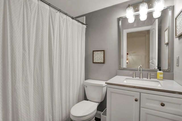 bathroom featuring toilet and vanity