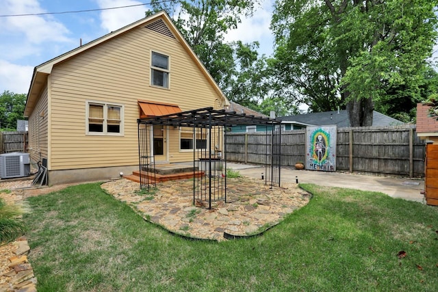 rear view of property with a pergola, a patio, a yard, and central AC unit