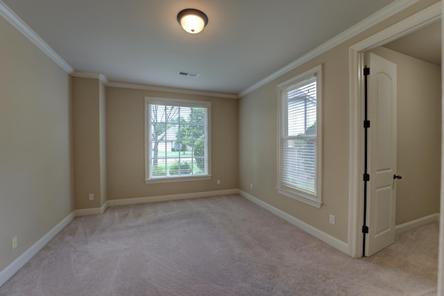 unfurnished room featuring ornamental molding and light carpet