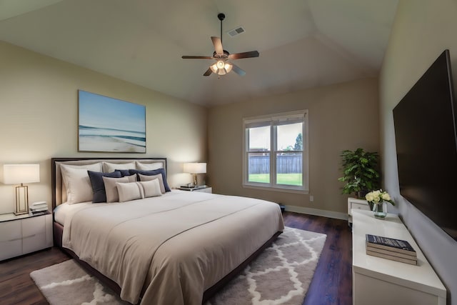 bedroom with vaulted ceiling, dark wood-type flooring, and ceiling fan