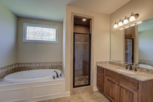 bathroom with vanity, tile patterned floors, and shower with separate bathtub